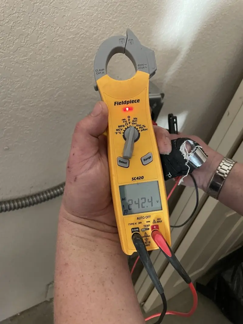 Voltage testing with clamp meter during Outlet Installation in Crooked River Ranch